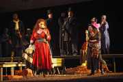 Carmen (mezzo-soprano Dana Beth Miller) contemplates new love as fellow gypsy Mercédès (mezzo-soprano Stephanie Chigas), Spanish soldiers, and cigarette girls look on., Carmen, Boston Lyric Opera, 2009