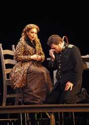 Don José (tenor John Bellemer) is overcome with emotion while hearing a message from his mother conveyed by the devout Micaëla (soprano Hanan Alattar)., Carmen, Boston Lyric Opera, 2009