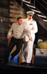 The Officer (tenor Neal Ferreira) refuses to let the Lackey (bass John Whittlesey) stop him from seeing the beautiful Zerbinetta in her dressing room., Ariadne auf Naxos, Boston Lyric Opera, 2010