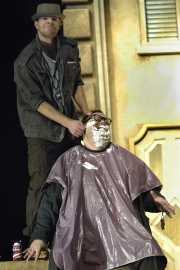 The barber of Seville, Figaro (baritone Gregory Gerbrandt), distracts his patron, Doctor Bartolo (bass-baritone T. Steven Smith) with a shave, Boston Lyric Opera, 2010