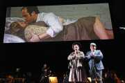 Flora (soprano Kathryn Skemp) and Miles (treble Aidan Gent) say their prayers while Quint (tenor Vale Rideout) and Miss Jessel (soprano Rebecca Nash) have an intimate moment behind the scenes, The Turn of the Screw, 2010