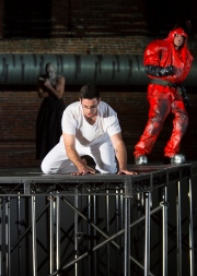 (L-R): Yury Yanowsky as the Man (rear), Neal Ferreira as The Visitor, and David McFerrin as The Officer in Boston Lyric Opera’s new “Opera Annex” production of Philip Glass’s dystopian “In the Penal Colony” based on the Franz Kafka short story, and in a limited run Nov 11-15 at the historic Cyclorama at the Boston Center for the Arts.