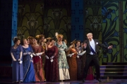 Roger Honeywell, as Count Danilo, surrounded by the ensemble in Boston Lyric Opera’s new production of The Merry Widow running April 29-May 8 at the Citi Shubert Theater.
