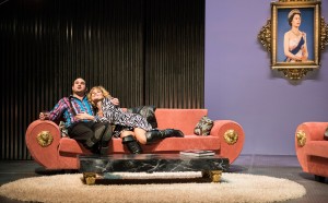 In the shadow of Queen Elizabeth, Eddy (Marcus Farnsworth) and his wife (Amanda Crider), revel in their newfound wealth in the Boston Lyric Opera production of Mark Anthony Turnage’s GREEK, running Nov 16-20 at the Emerson/Paramount Center.
