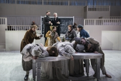 FRESHER BETTER -- As the disturbingly fresh corpses pile up in 1828 Scotland (foreground), Burke, Hare and their companions (center) celebrate newfound wealth, while anatomy school purveyors Dr. Ferguson (David McFerrin, rear left) and Dr. Knox (William Burden, rear right) face a bright future in Boston Lyric Opera’s world premiere production of THE NEFARIOUS, IMMORAL BUT HIGHLY PROFITABLE ENTERPRISE of MR. BURKE and MR. HARE by composer Julian Grant and librettist Mark Campbell. Runs Nov 8-12; details at BLO.org.
