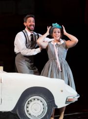 In the Count’s garage where he keeps the cars in tip-top shape, Figaro (Evan Hughes, r.) helps Susanna (Emily Birsan) imagine their upcoming nuptials in Boston Lyric Opera’s new production of “The Marriage of Figaro” running through May 7 at John Hancock Hall