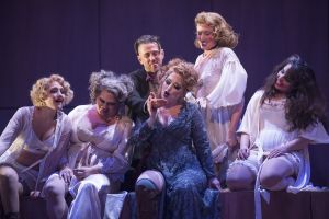 Jenny (Renee Tatum, in blue) reads the palm of Macheath (Christopher Burchett, center, top) in the Boston Lyric Opera’s production of Weill and Brecht’s THE THREEPENNY OPERA, running March 16-25 at the Huntington Avenue Theatre.  BLO.org.