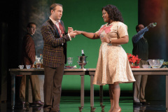 At the State Department Christmas party, Hawkins Fuller (Jesse Blumberg, l.) meets Lucy (Brianna Robinson) for the first time in Boston Lyric Opera’s production of “Fellow Travelers,” playing Nov. 13-17 at the Emerson Paramount Center.