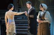 When he arrives at her home under the pretense of needing shelter, Tarquinius (Duncan Rock) greets Lucretia (Kelley O’Connor, l.) while her maid Lucia (Sarah Womble, r.) is suspicious of his motive in Boston Lyric Opera’s production of “The Rape of Lucretia” March 11-17 at Artists for Humanity EpiCenter.