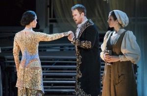 When he arrives at her home under the pretense of needing shelter, Tarquinius (Duncan Rock) greets Lucretia (Kelley O’Connor, l.) while her maid Lucia (Sarah Womble, r.) is suspicious of his motive in Boston Lyric Opera’s production of “The Rape of Lucretia” March 11-17 at Artists for Humanity EpiCenter.
