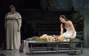 The morning after Tarquinius has violated her, Lucretia (Kelley O’Connor, kneeling) comes into the garden dazed, angry and confused and her nurse Bianca (Margaret Lattimore, l.) struggles to understand what has happened in Boston Lyric Opera’s production of “The Rape of Lucretia” March 11-17 at Artists for Humanity EpiCenter.