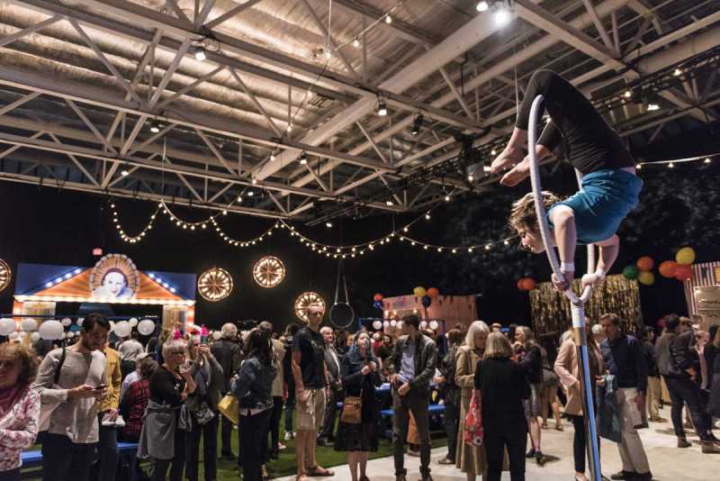 At the Pagliacci Fairgrounds preshow event, Boston Lyric Opera patrons take part in midway games, hear community choruses, and enjoy circus acts by youth members of the Jamaica Plain-based non-profit Circus Up.