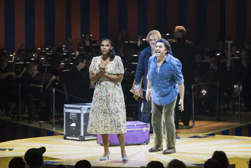 As Tonio (Michael Mayes, rear) eggs him on, theater troupe leader Canio (Rafael Rojas, r.) threatens his wife Nedda (Lauren Michelle) over her suspected affair with Silvio in Boston Lyric Opera’s production of Ruggero Leoncavallo’s Pagliacci.