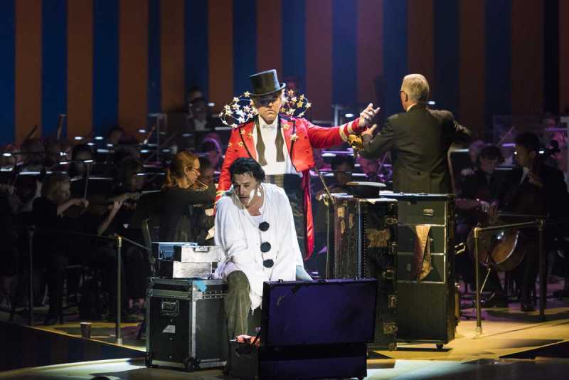 As the troupe prepares for its onstage performance, Canio (Rafael Rojas, seated) despairs over his wife’s infidelity as Tonio (Michael Mayes, in Taddeo’s Ringmaster costume) looks on in Boston Lyric Opera’s production of Ruggero Leoncavallo’s Pagliacci.
