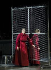 Moira (Chelsea Basler) tells Offred (Jennifer Johnson Cano) about her plans to escape the Handmaid life in Boston Lyric Opera’s production of “The Handmaid’s Tale,” running through May 12
